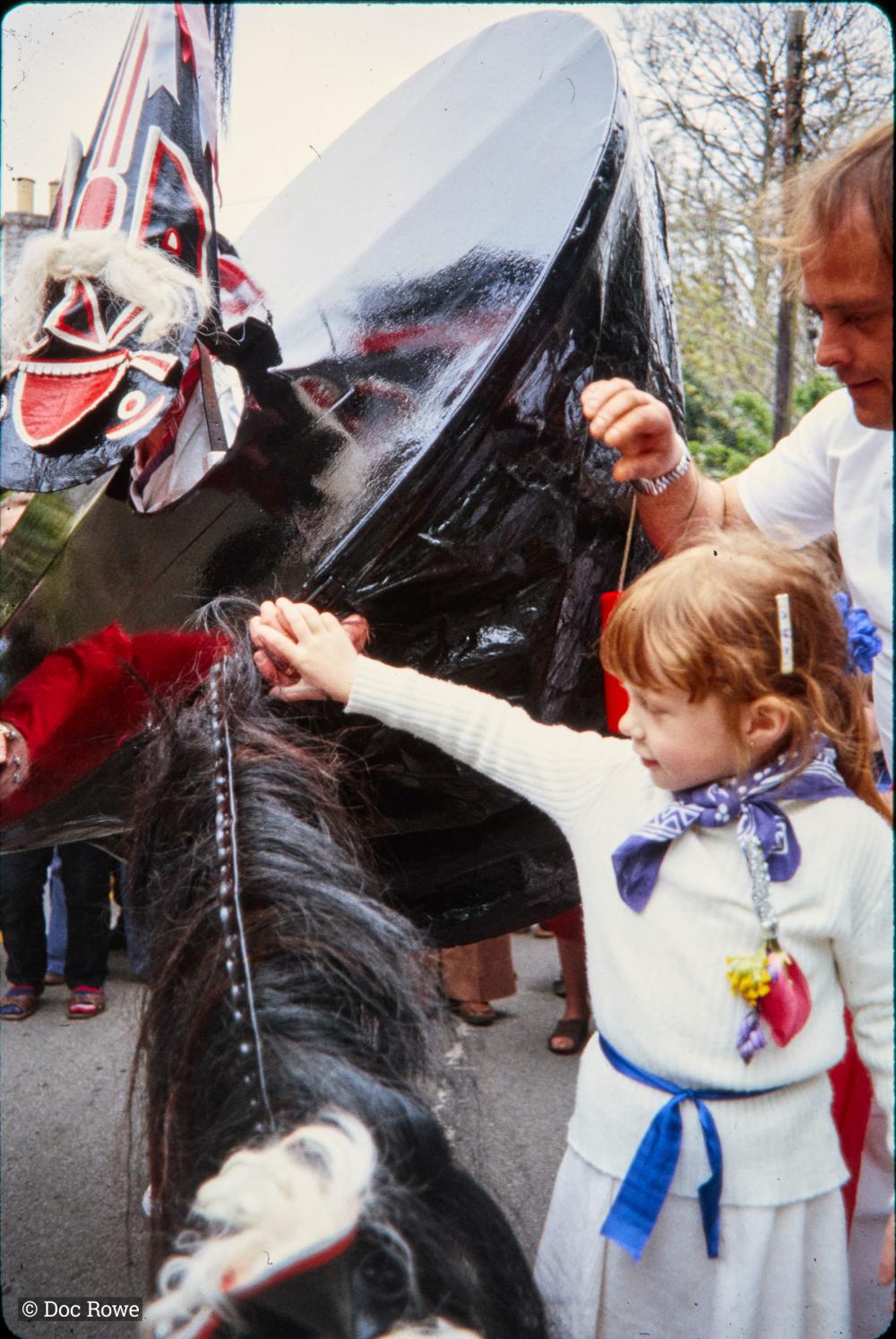 Old Oss being stroked by little girl and man