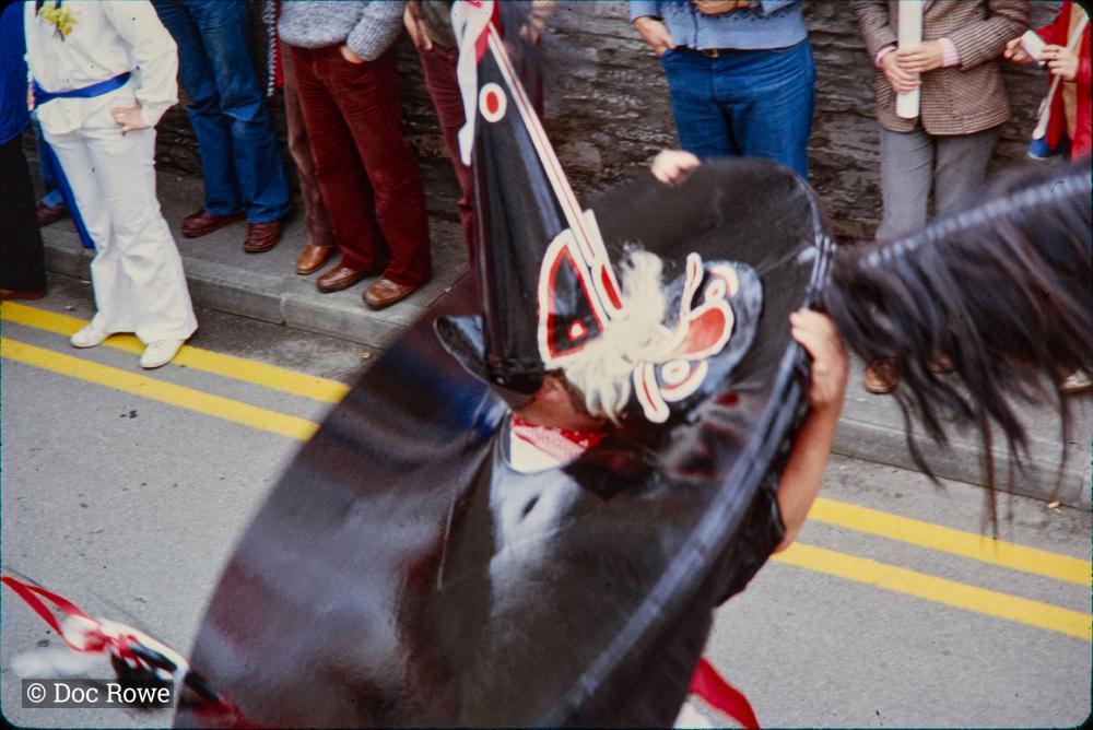 Child putting on Old Oss hat