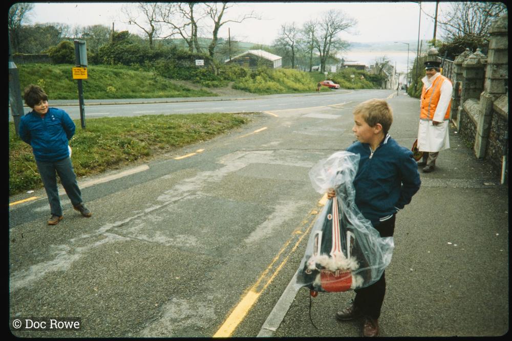 Boys on pavement with Oss hat in bag
