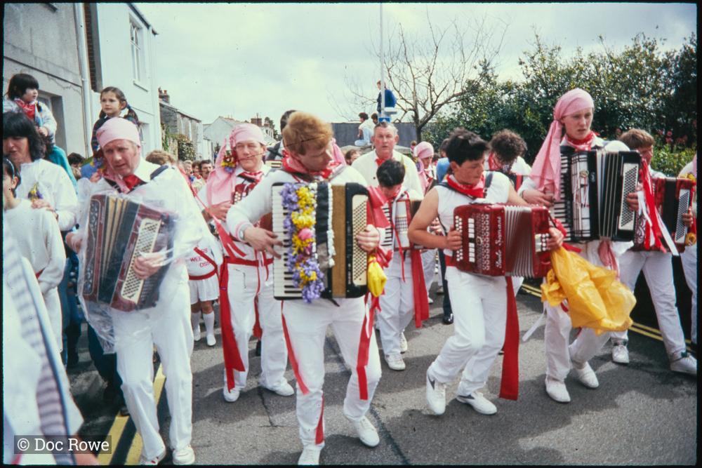 Old Oss accordion players walking in procession 