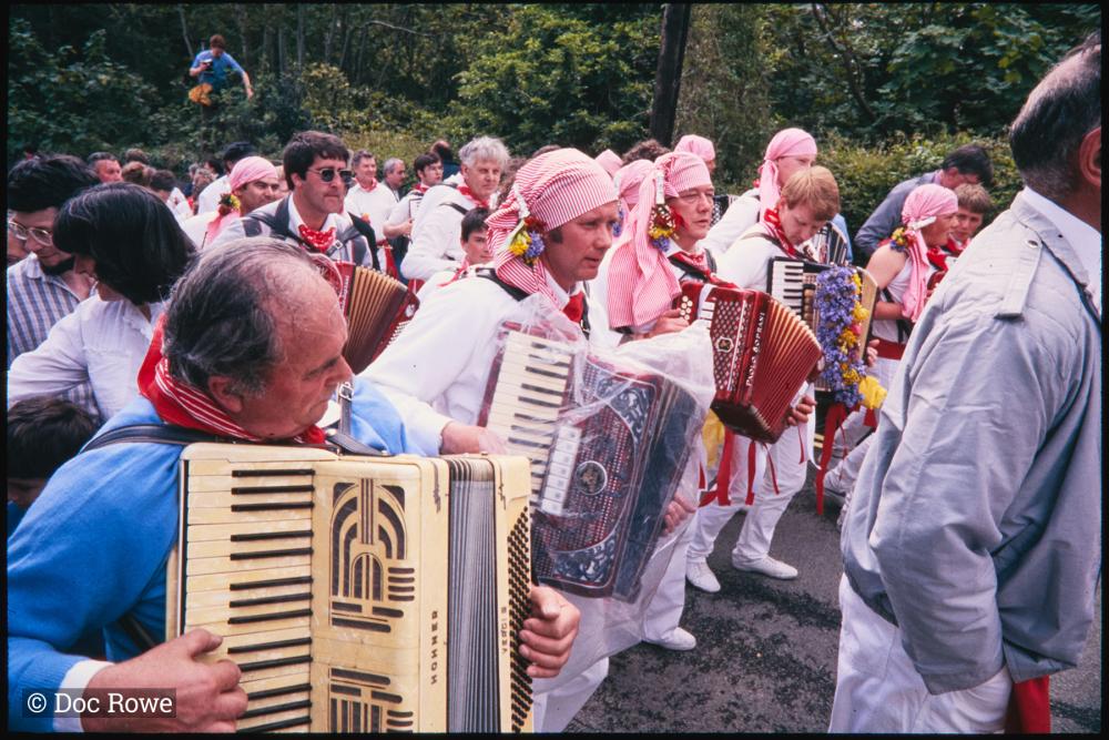 Old Oss accordion players walking in procession
