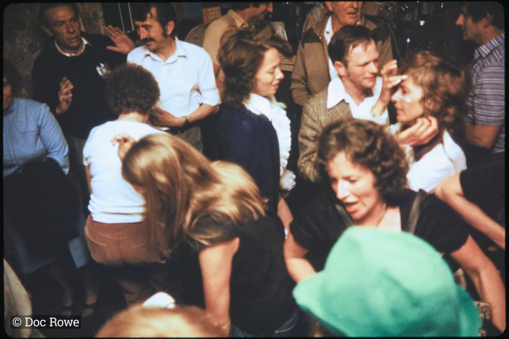 People dancing in fancy dress in pub